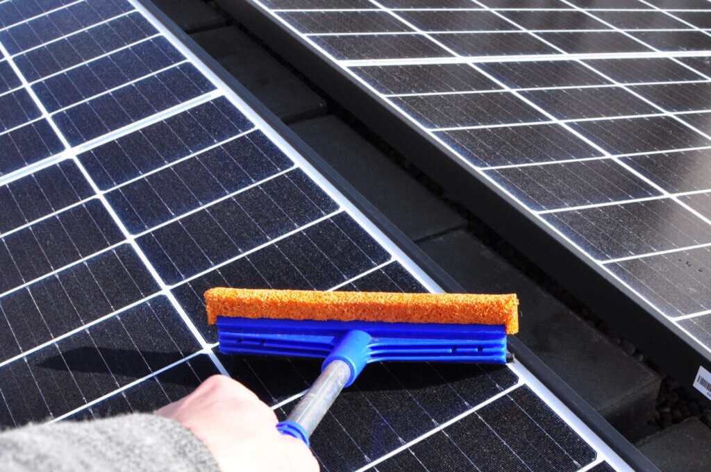 cleaning-solar-panels-with-a-wiper-2022-11-02-18-04-13-utc Solar Panel Washing